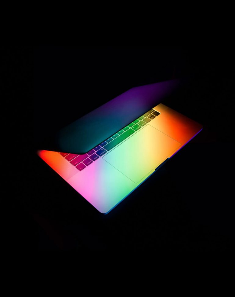 rainbow light coming from a macbook pro over a black background, The Future of Branding