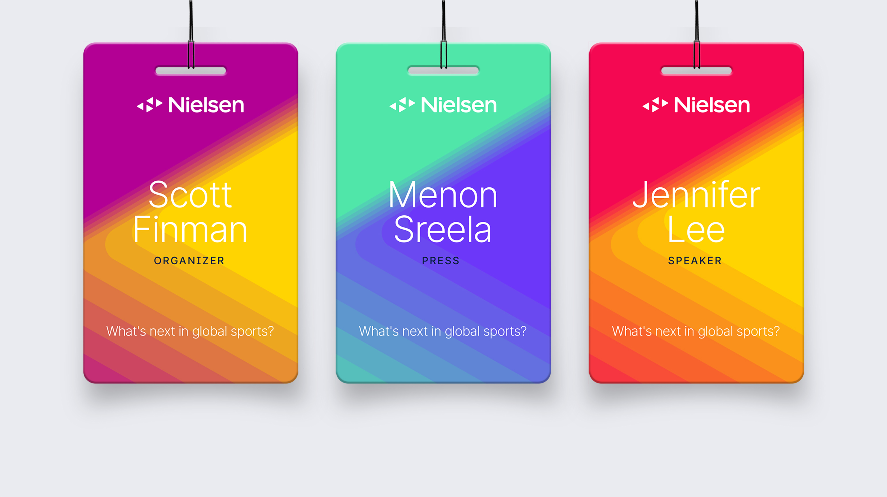 Three multicolored Nielsen ID badges showing Nielsen's new brand identity