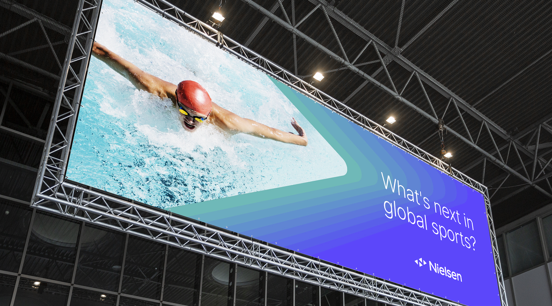 Blue Nielsen Billboard with a professional swimmer next to text that says “what’s next in global sports?” 