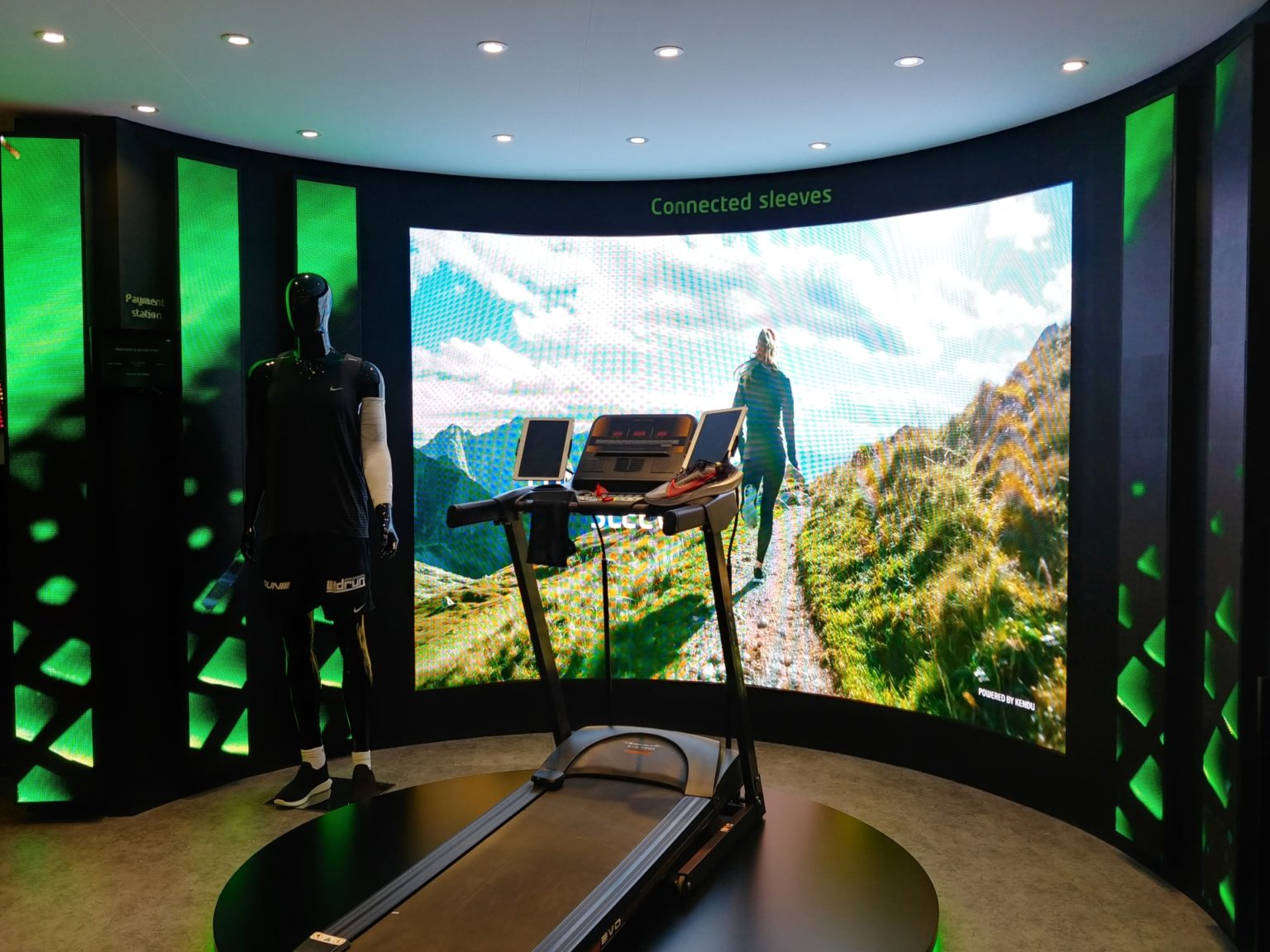 Black treadmill facing towards a screen with a runner on a trail from Etisalat's pilot for new retail technologies at Gitex