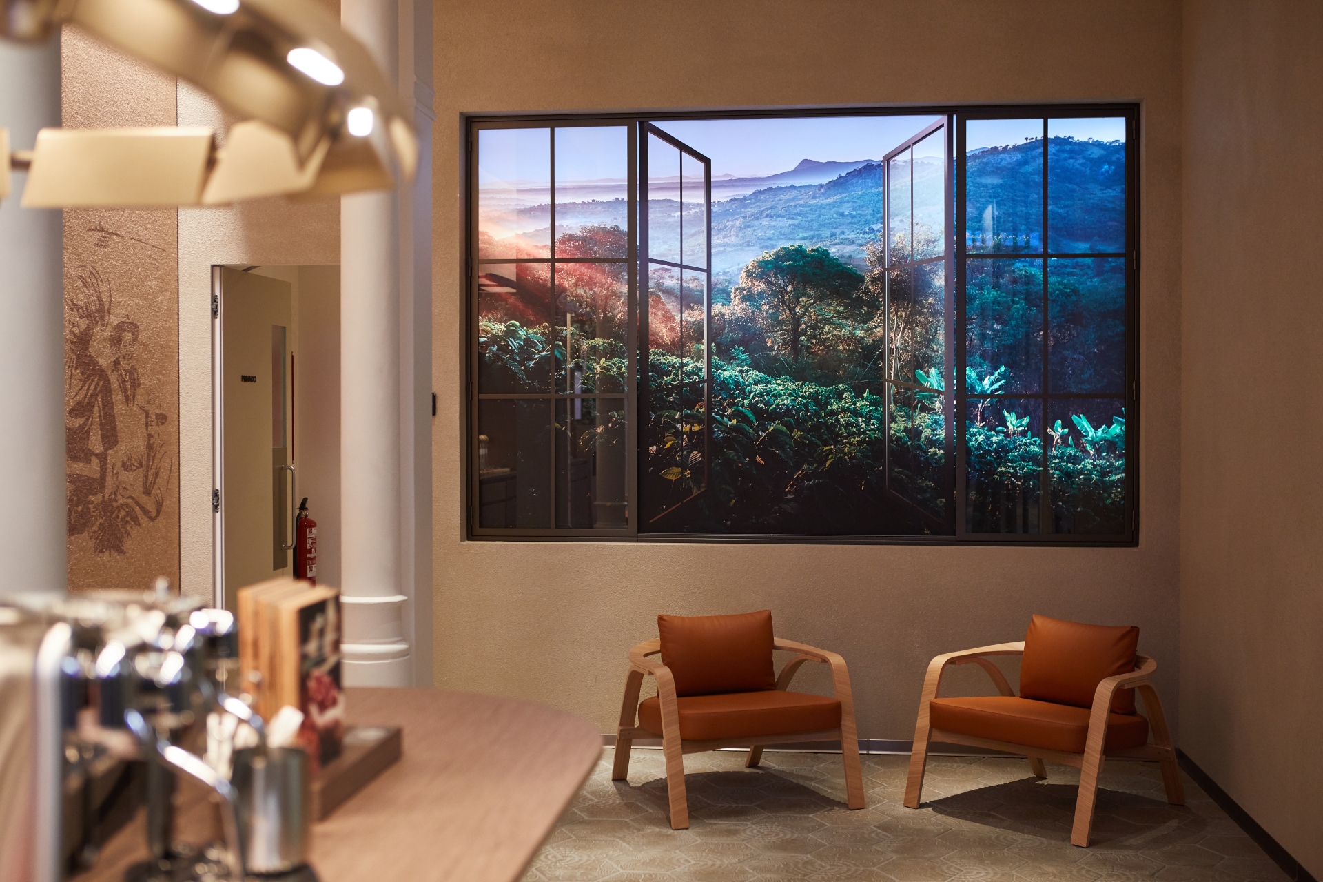 Room with two chairs and a window looking out to the jungle in  Nespresso’s “Farm to Window” campaign