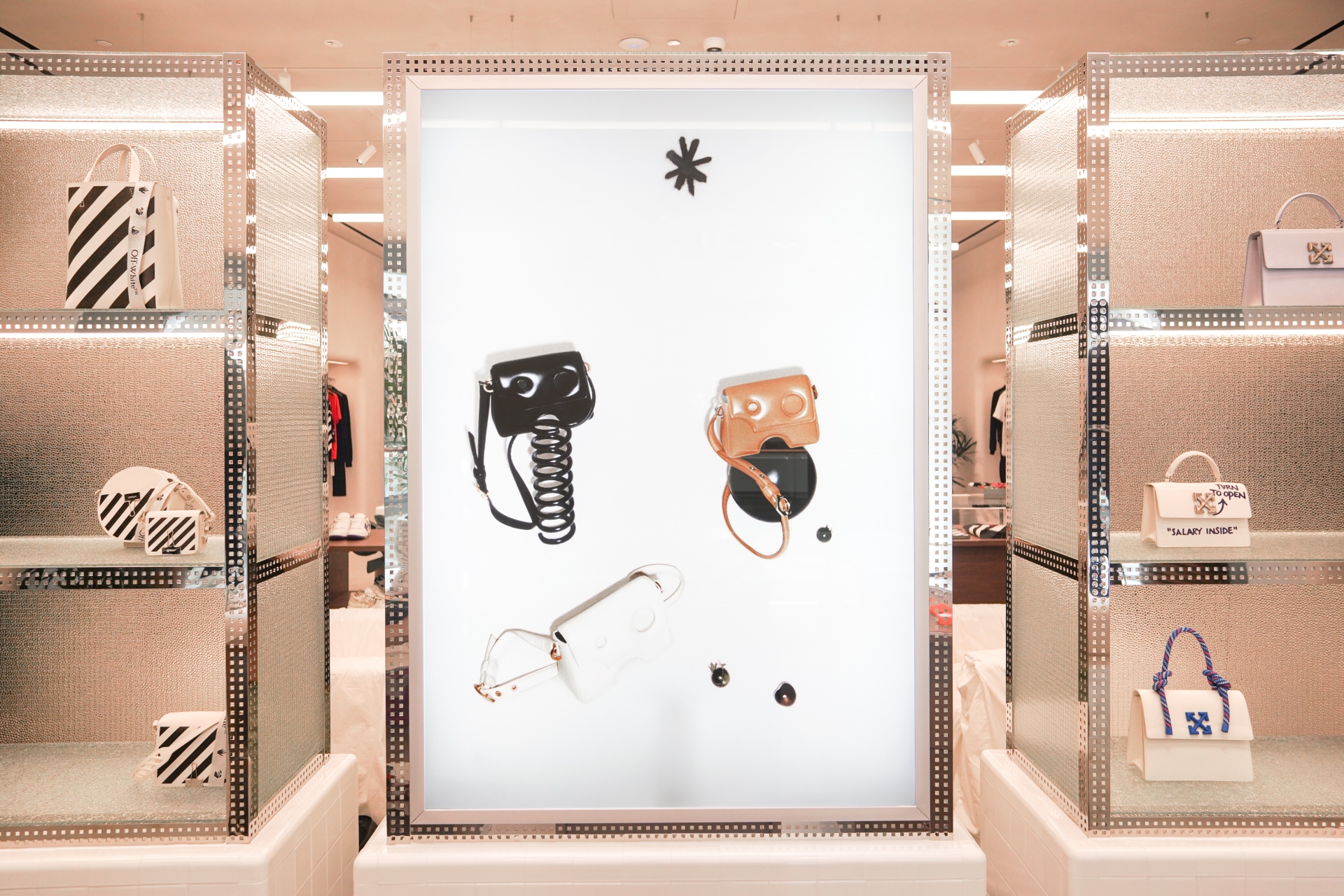 Luxury brand, Off-White, modular approach to the retail experience with white, black, and brown purses on display in store