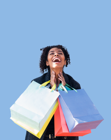 Happy shopper holding multiple shopping bags, creating a great customer experience