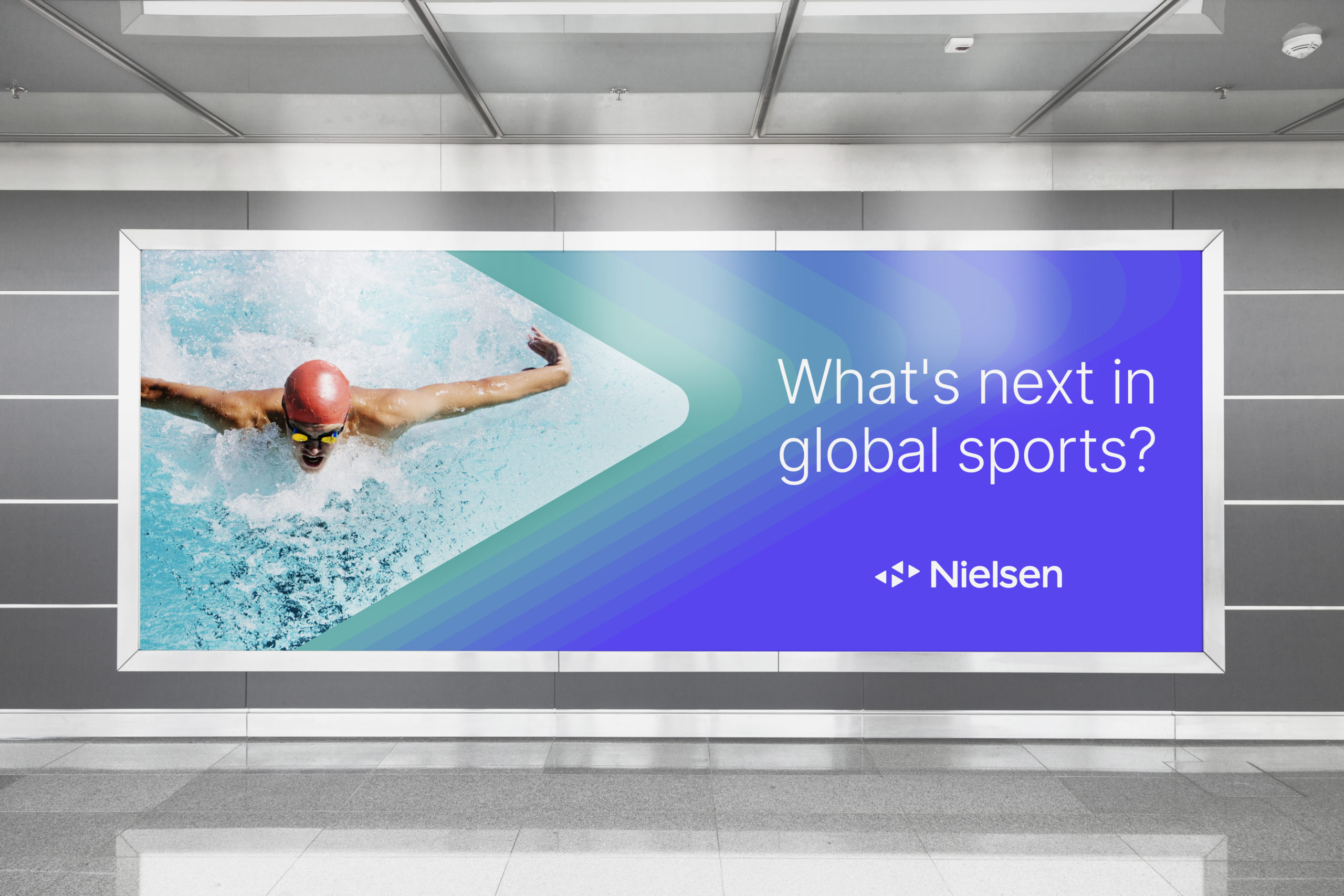 Blue Nielsen Poster with a professional swimmer next to text that says “what’s next in global sports?”
