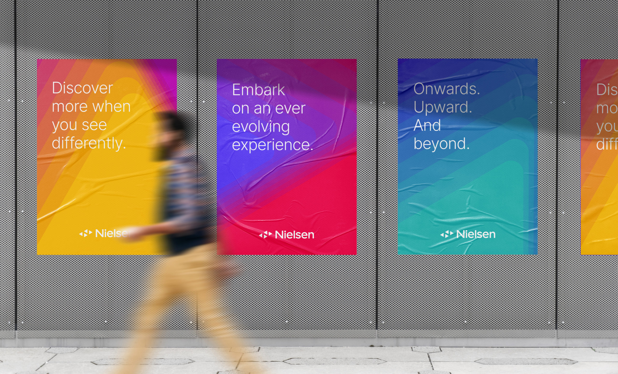 4 newly designed Nielsen posters on a wall in New York City